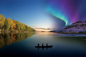 Three men paddling canoe on lake